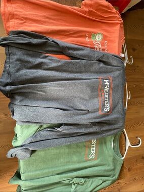 5 McAlisters shirts including 1 long sleeve and 4 short sleeve t-shirts.